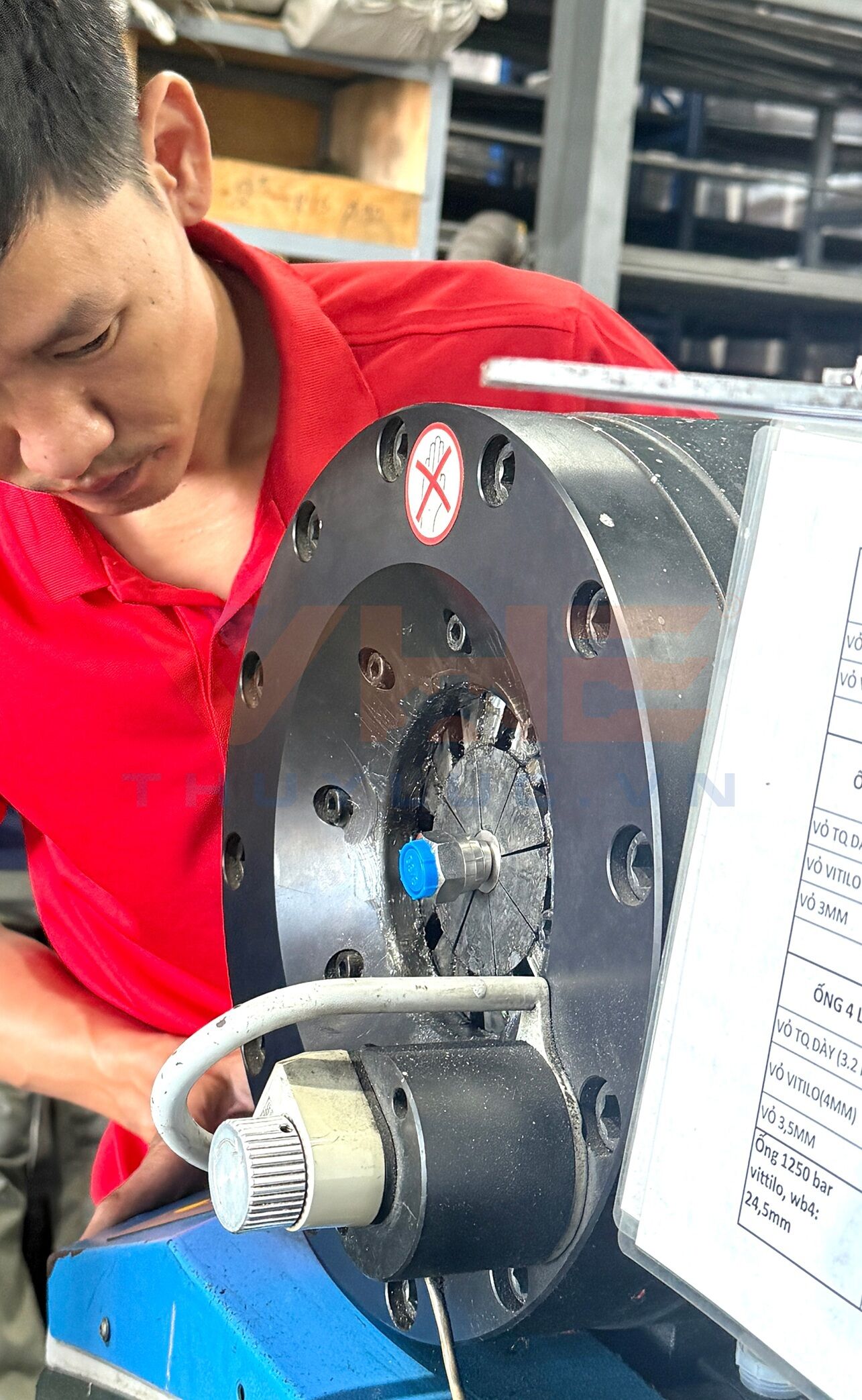 Custom stainless steel overbraiding services for hydraulic hoses at VHE workshop