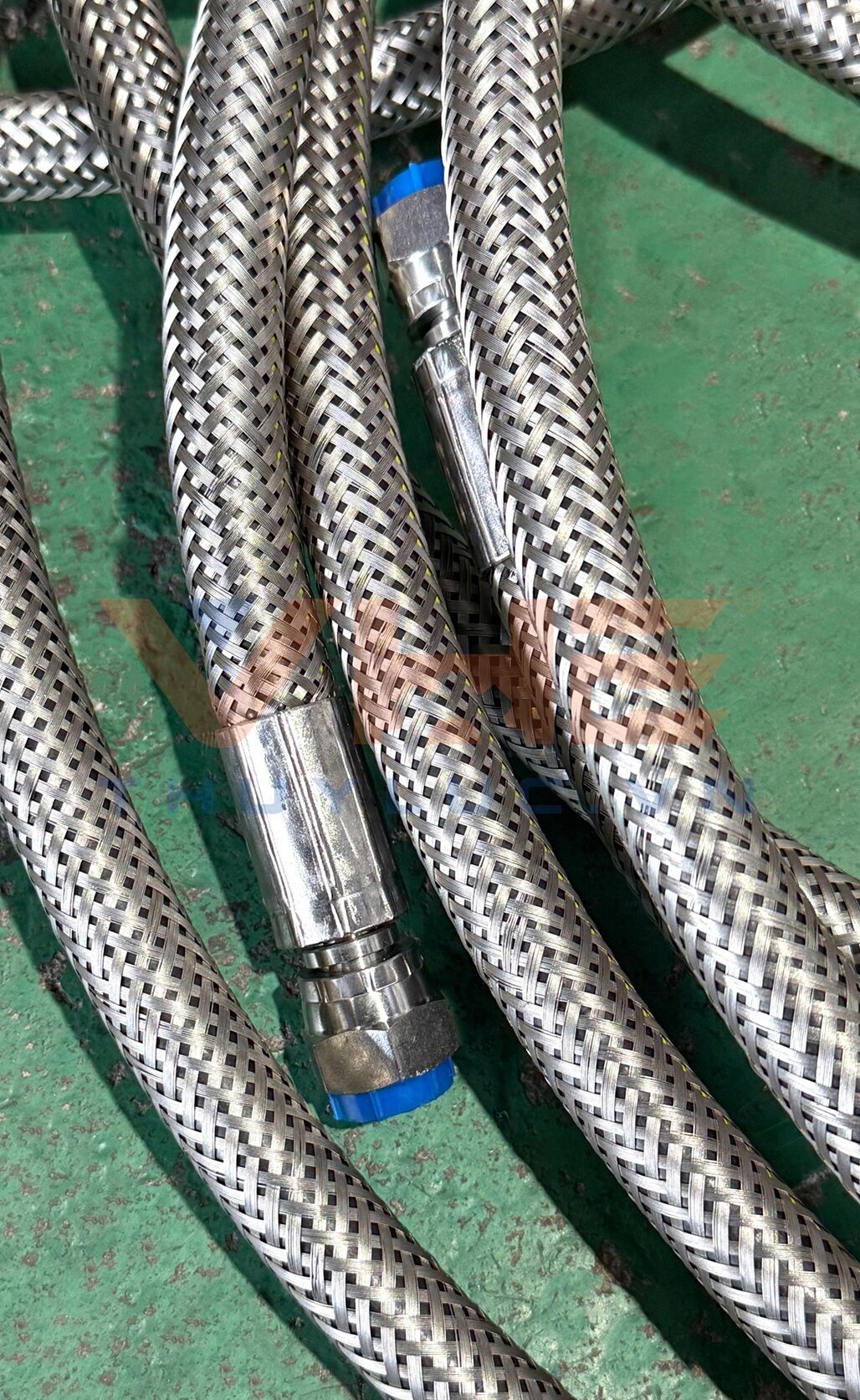 Custom stainless steel overbraiding services for hydraulic hoses at VHE workshop