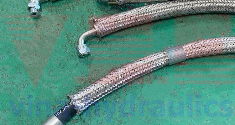 4-layer No-Skive Parker steel hydraulic hose, 1 straight, 1 curved and covered with stainless steel mesh